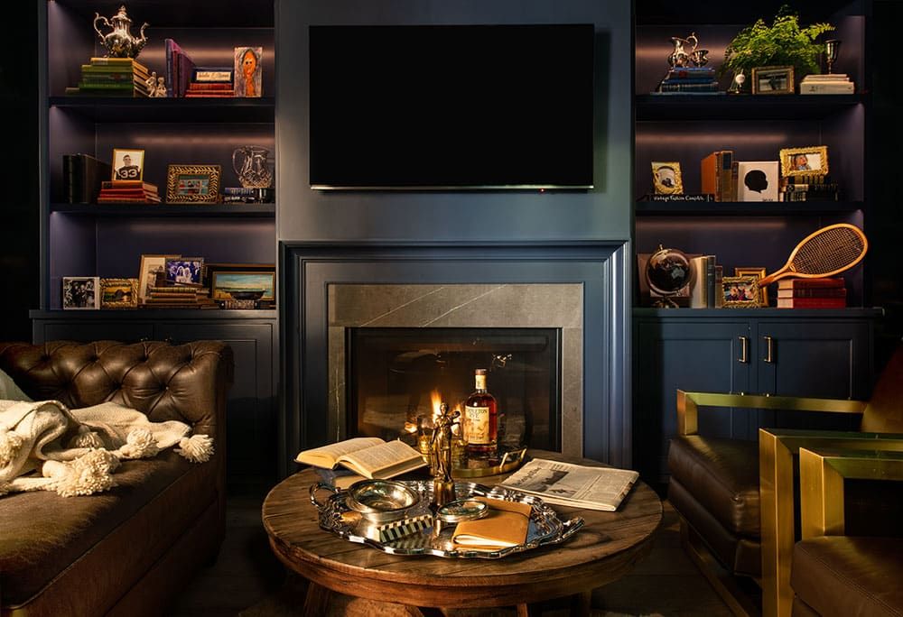 Cigar room with fireplace and built-in shelving