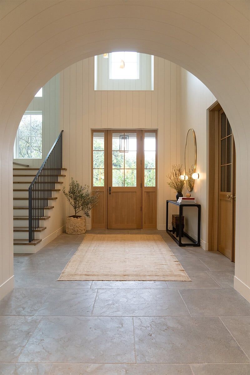Arched entry hall with oak door