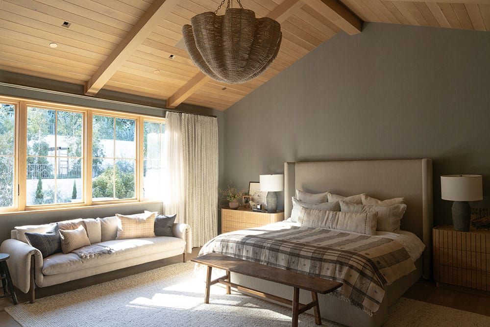 Primary bedroom with vaulted wood ceiling
