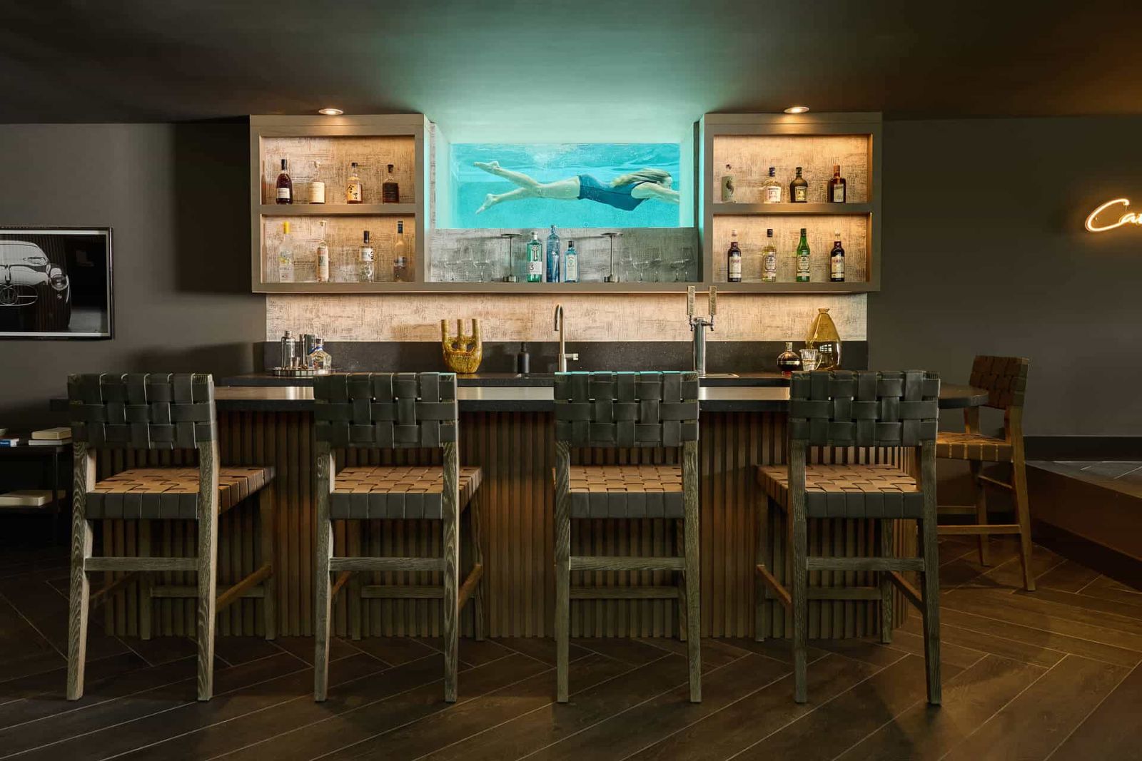 Custom bar with woven stools and open shelving