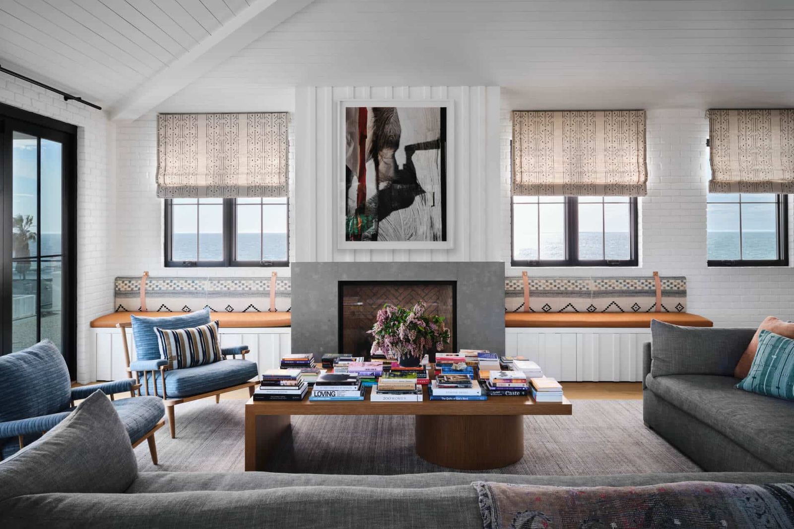 Living room with stone fireplace and ocean light