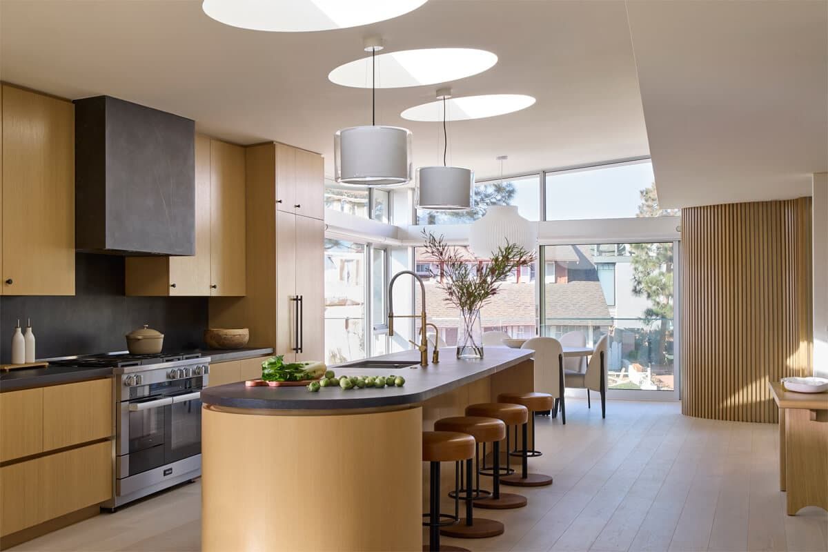 Curved island kitchen with wood cabinetry