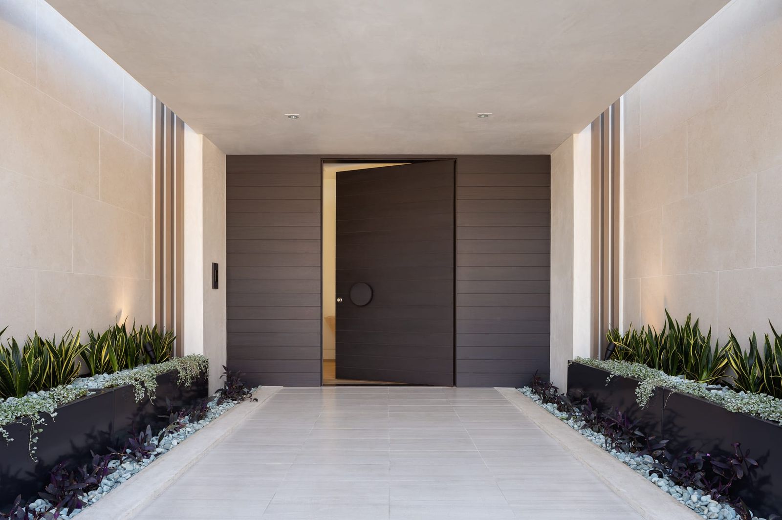 Entry corridor with planted borders and oak door